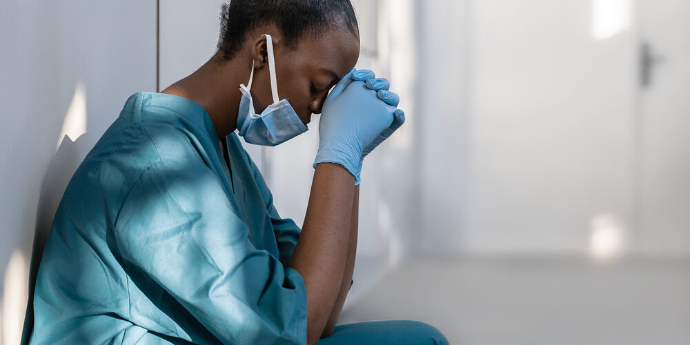 Tired,Depressed,Female,African,Scrub,Nurse,Wears,Face,Mask,Blue